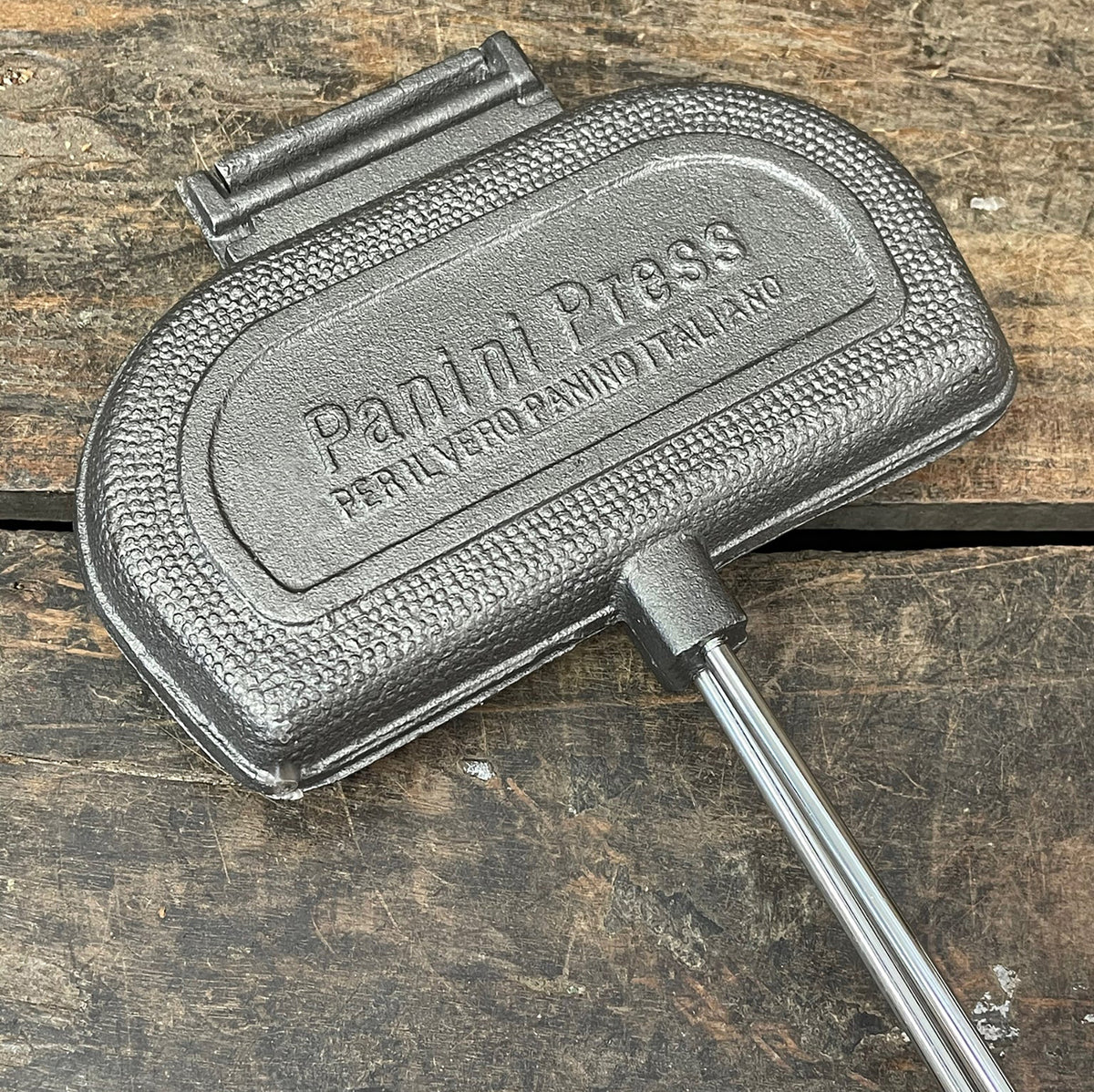 Panini Press cooking head close up wood background
