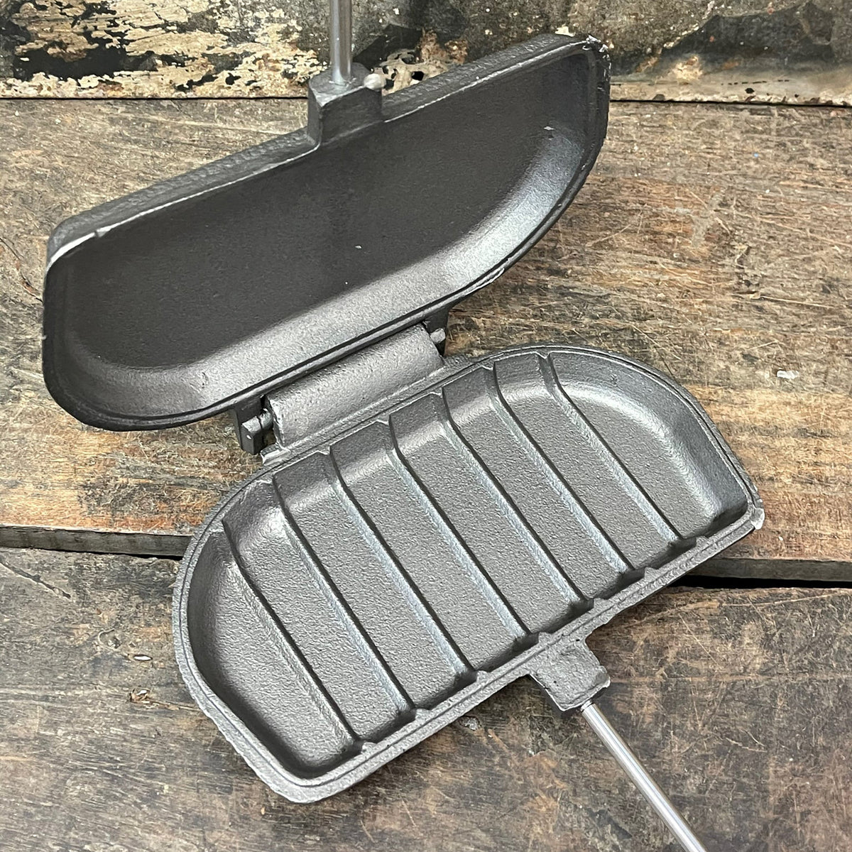 Panini Press cooking head close up open view wood background