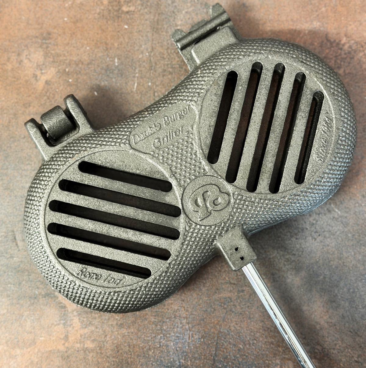Cast Iron Double Burger Griller cooking head close up gray background