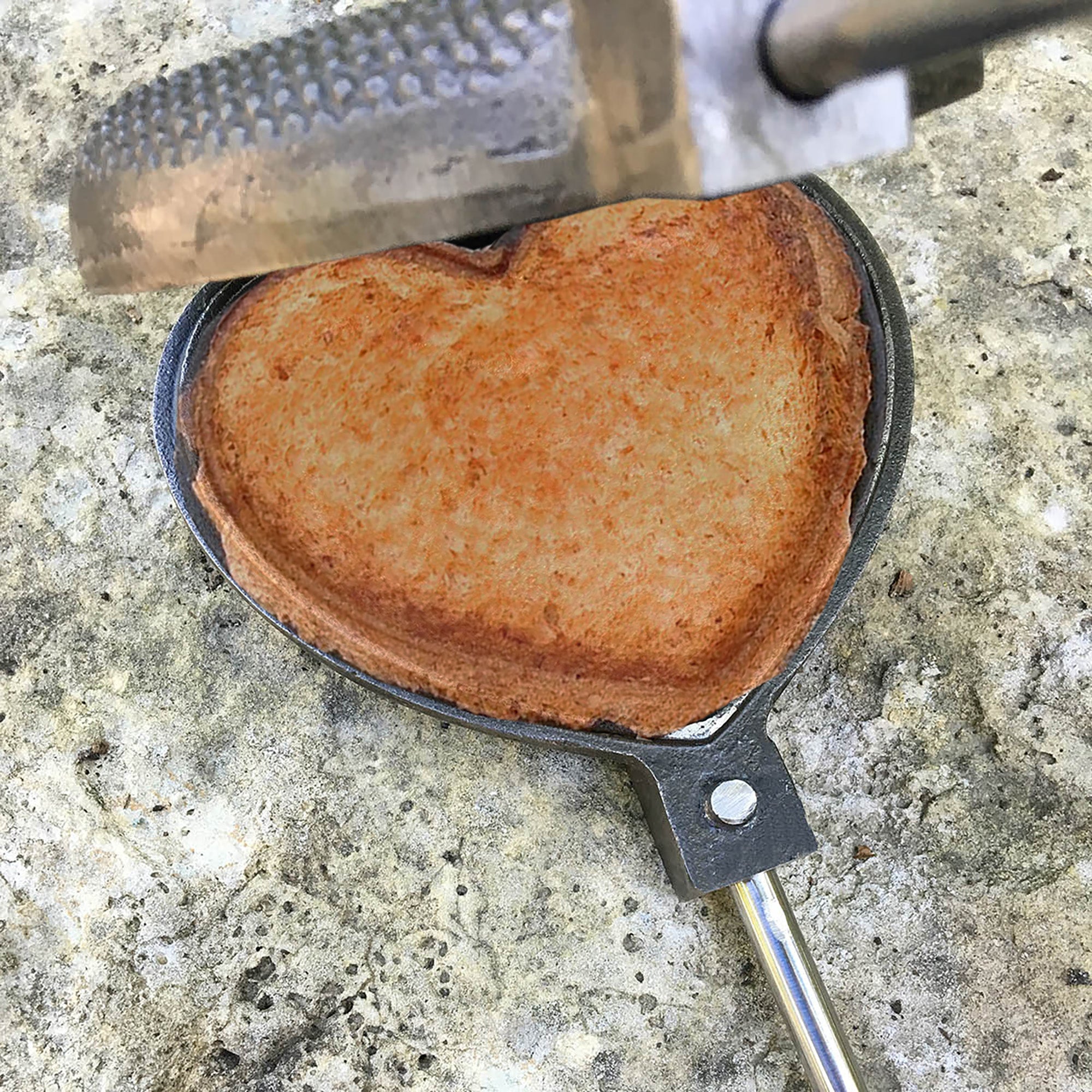 Love Pie Iron close up open with food gray background