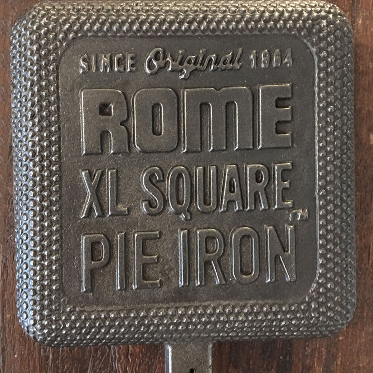 XL Square Pie Iron cooking head close up wood background