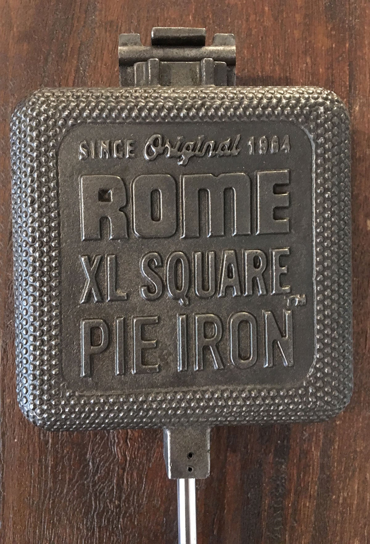 XL Square Pie Iron cooking head close up wood background