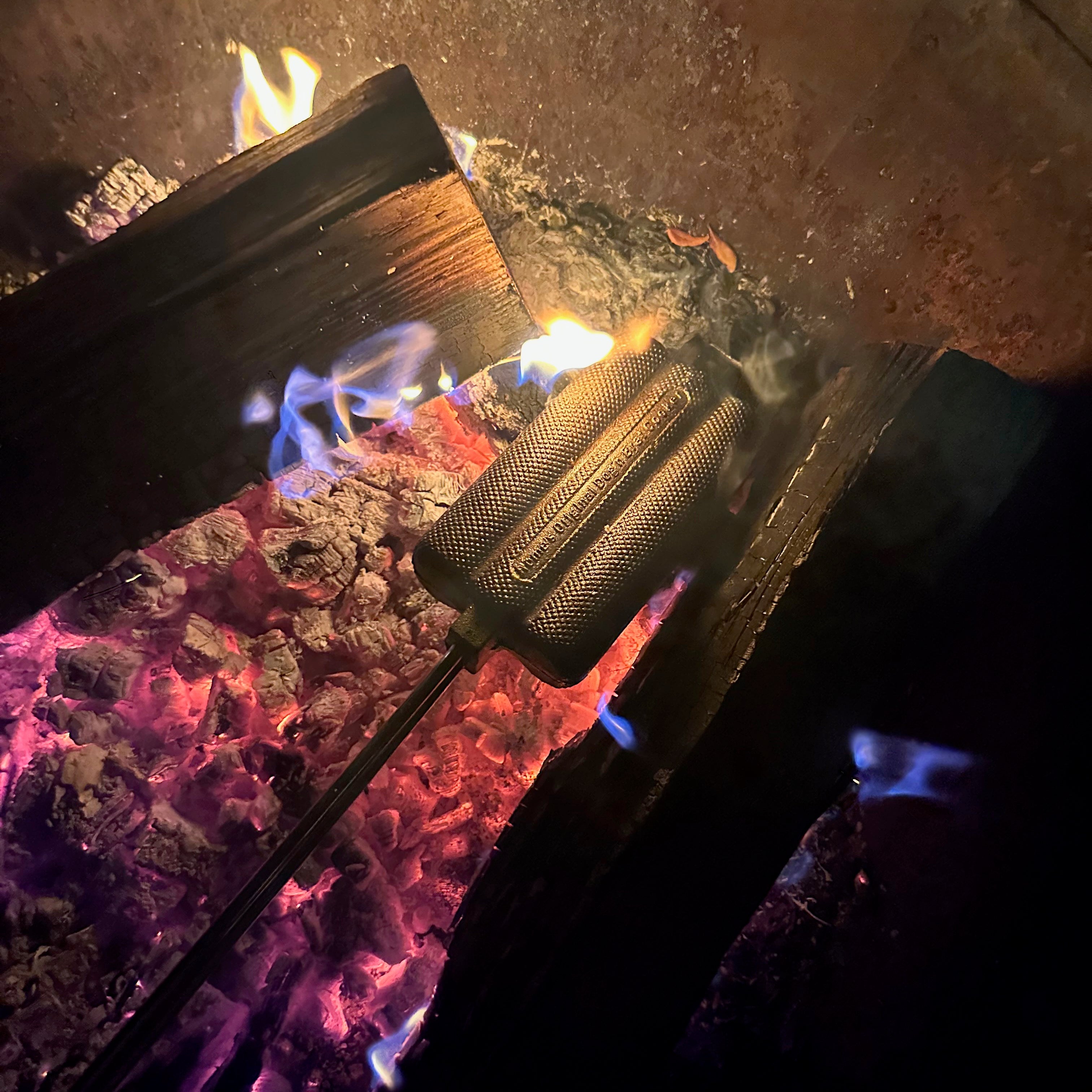 Dong N Brat Cooker in use in fire pit