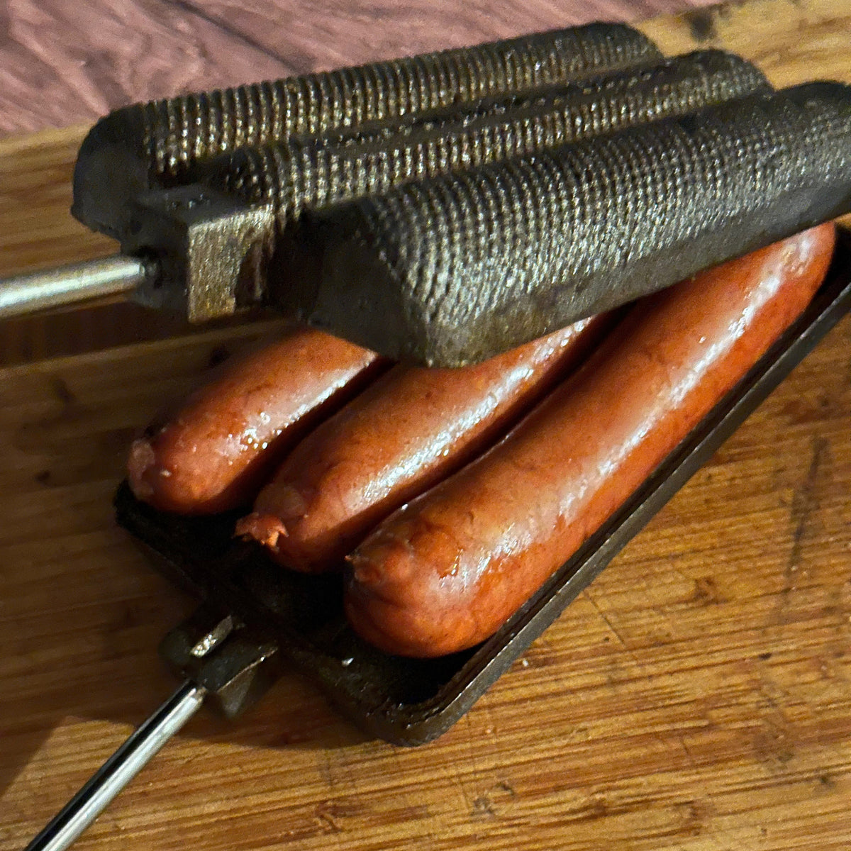 Dog N Brat Cooker with cooked brats close up open view