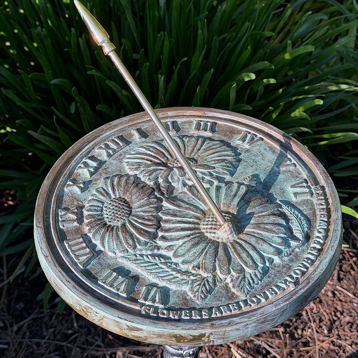 Solid Brass Flowers Sundial in garden close up