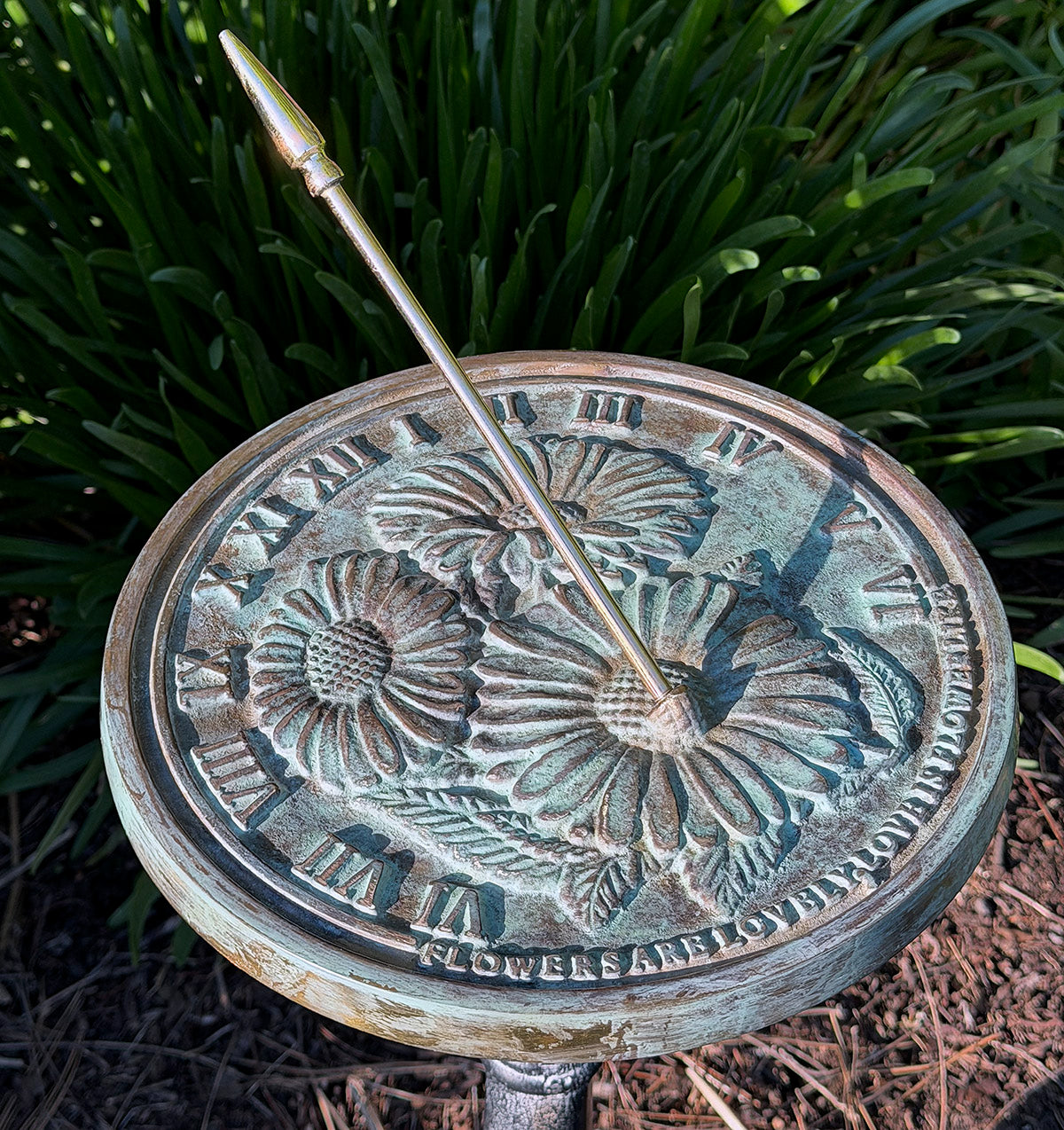 Solid Brass Flowers Sundial in garden close up