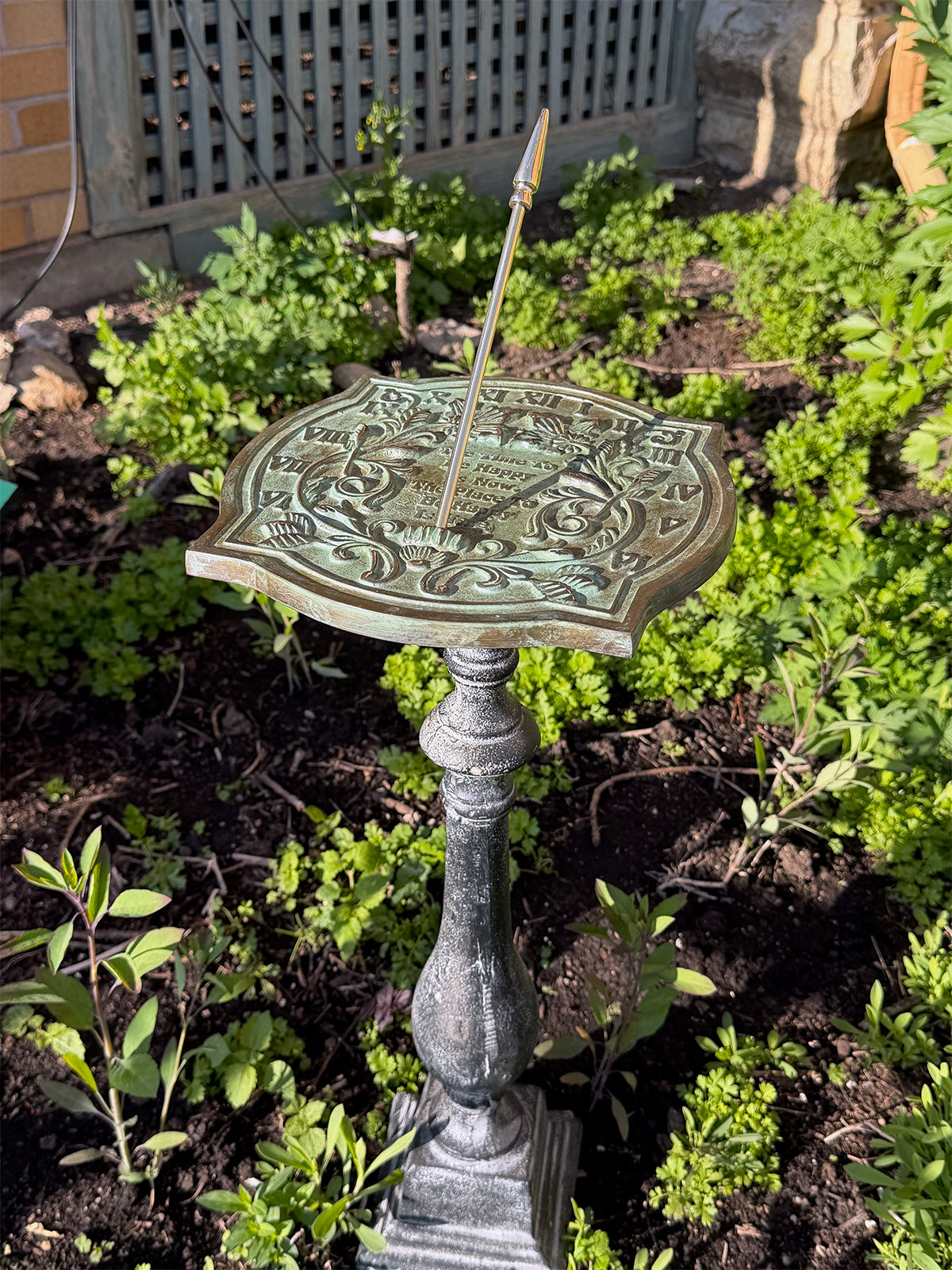 Solid Brass Happiness Sundial on pedestal in garden full view