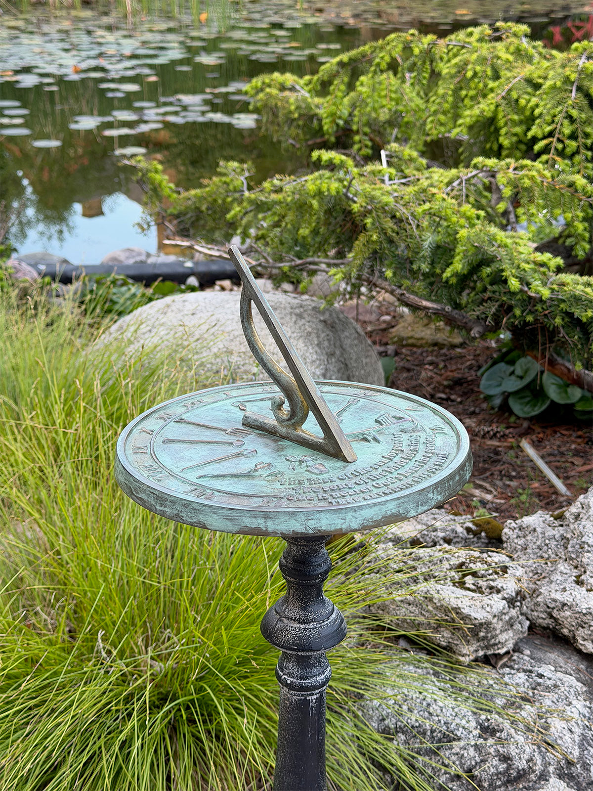 Solid Brass Kiss Of The Sun Sundial on pedestal in garden b